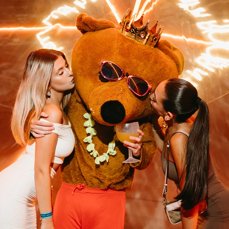 Two beautiful girls kissing Bear costuma Lust in Rio